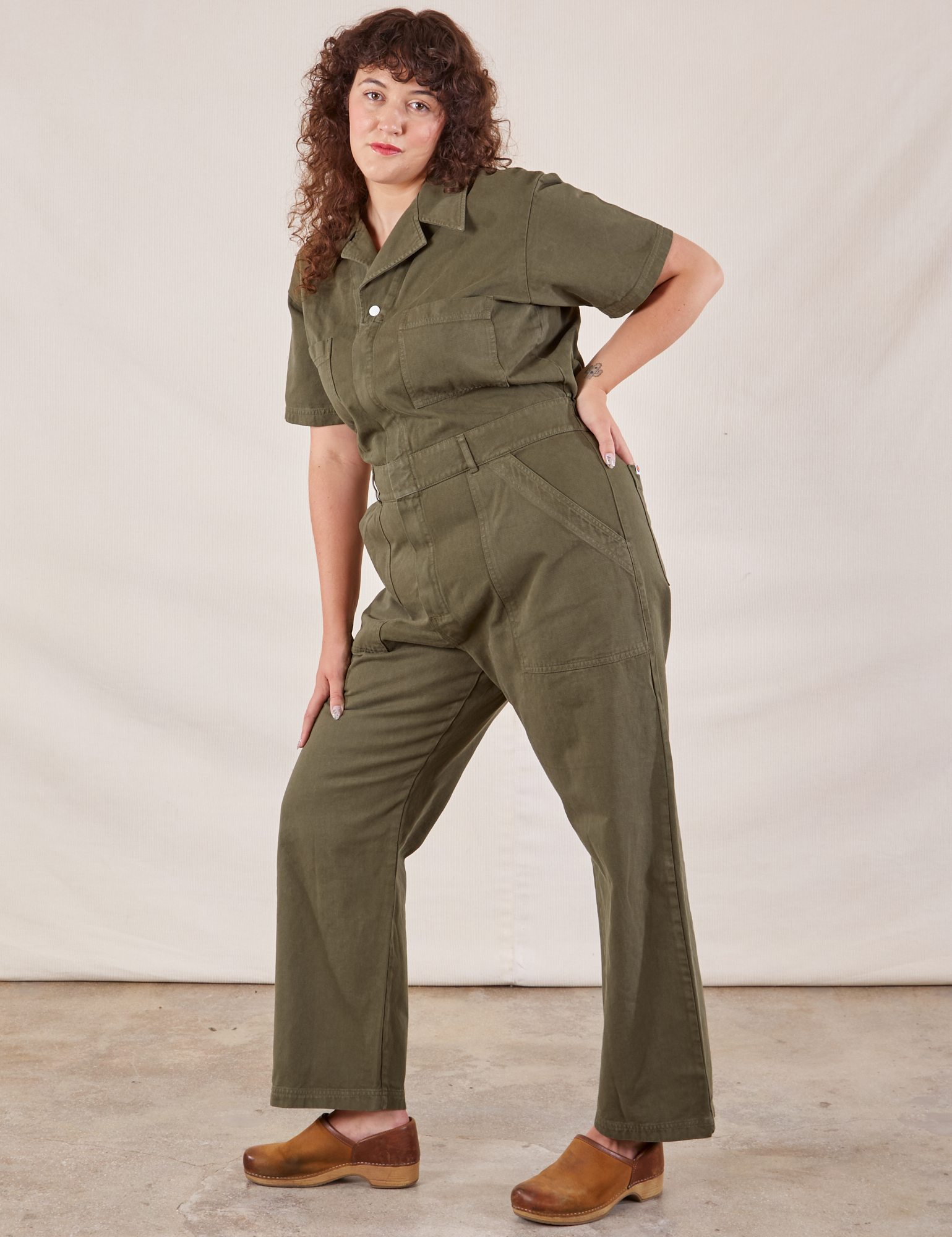 Short Sleeve Jumpsuit in Surplus Green angled front view on Ryan