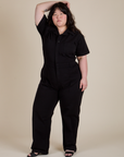Ashley is 5'7" and wearing 1XL Short Sleeve Jumpsuit in Basic Black