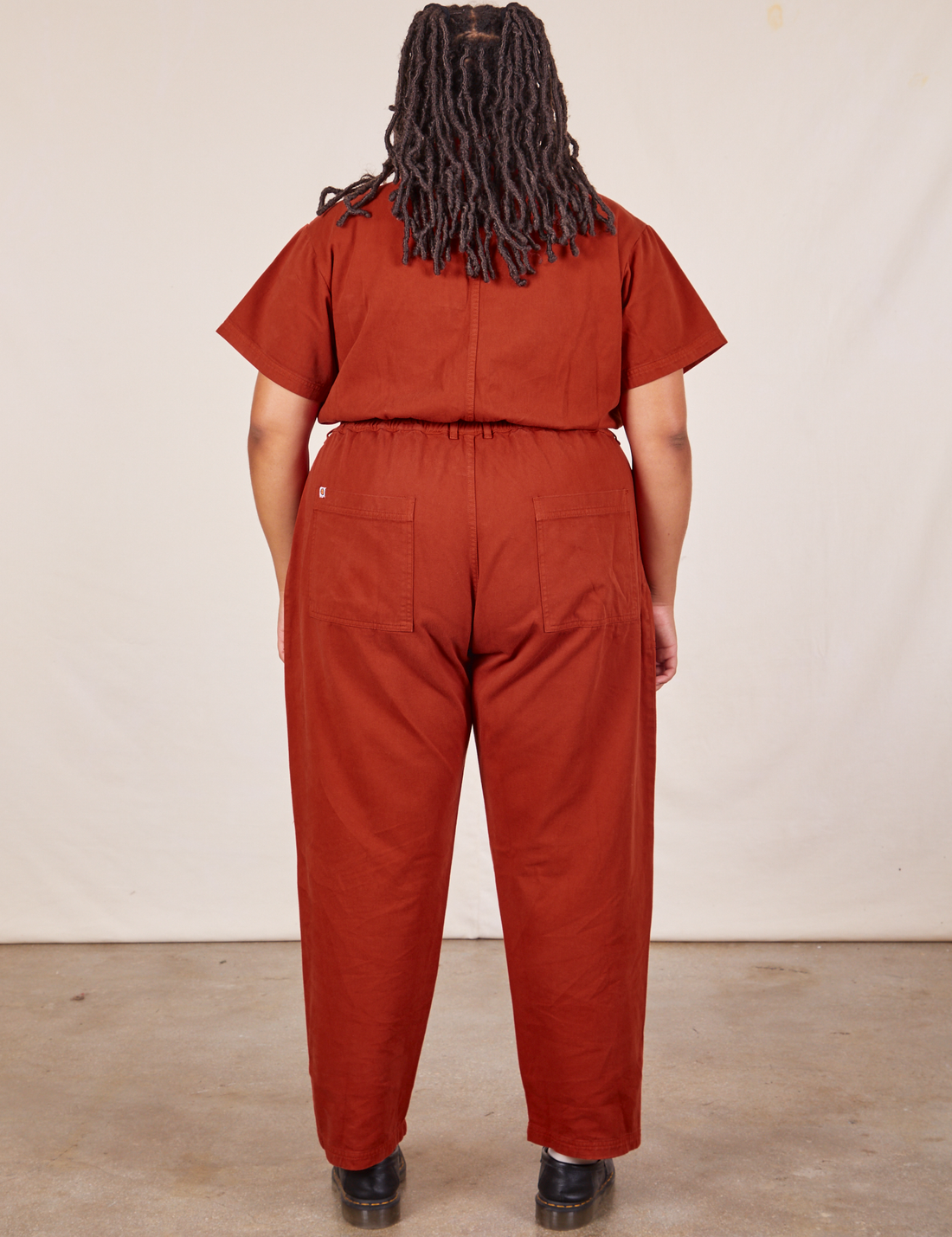 Back view of Short Sleeve Jumpsuit in Paprika worn by Alicia