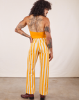 Back view of Work Pants in Lemon Stripe and mustard yellow Halter Top on Jesse