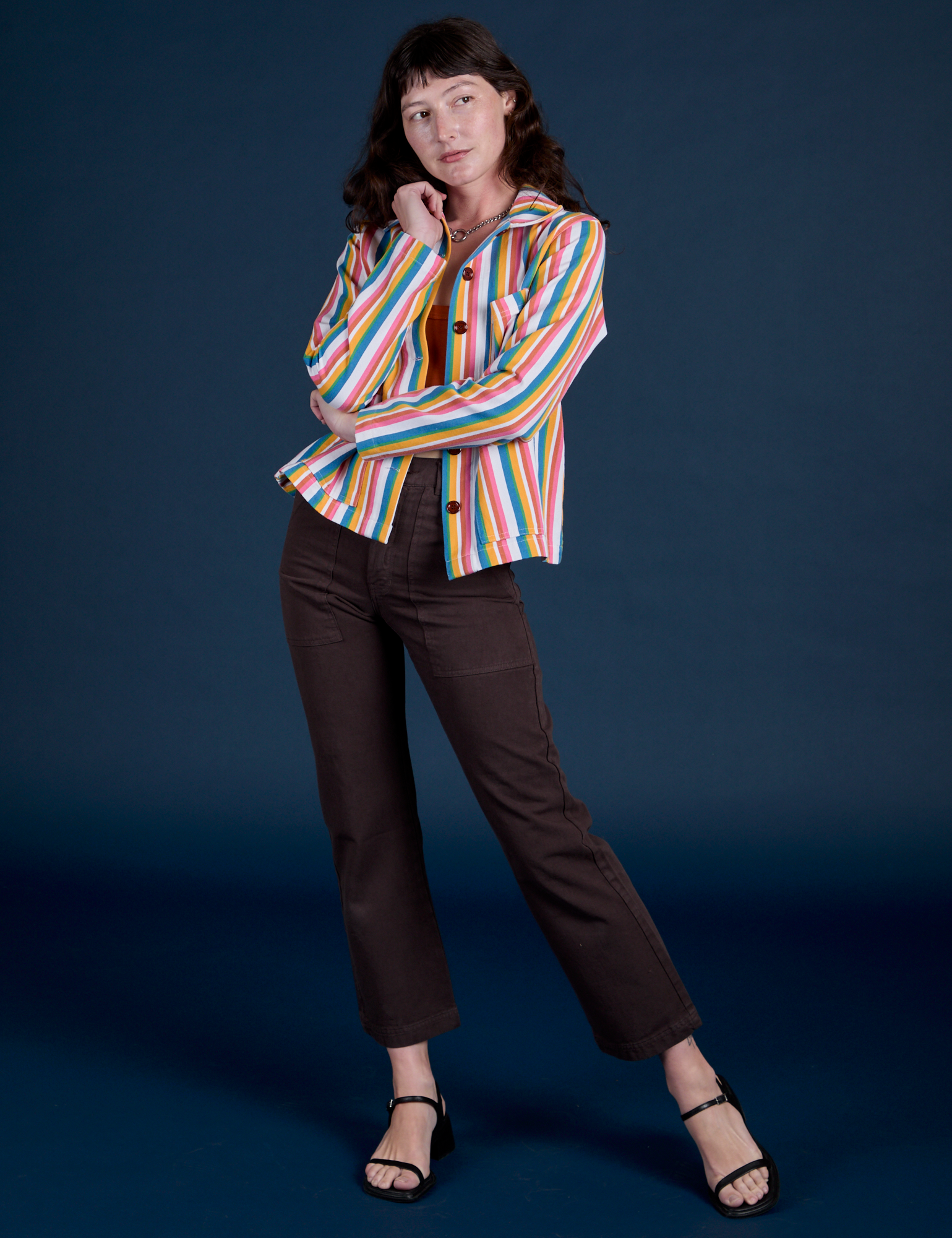 Alex is wearing Stripe Work Jacket in Rainbow Stripe paired with espresso brown Work Pants