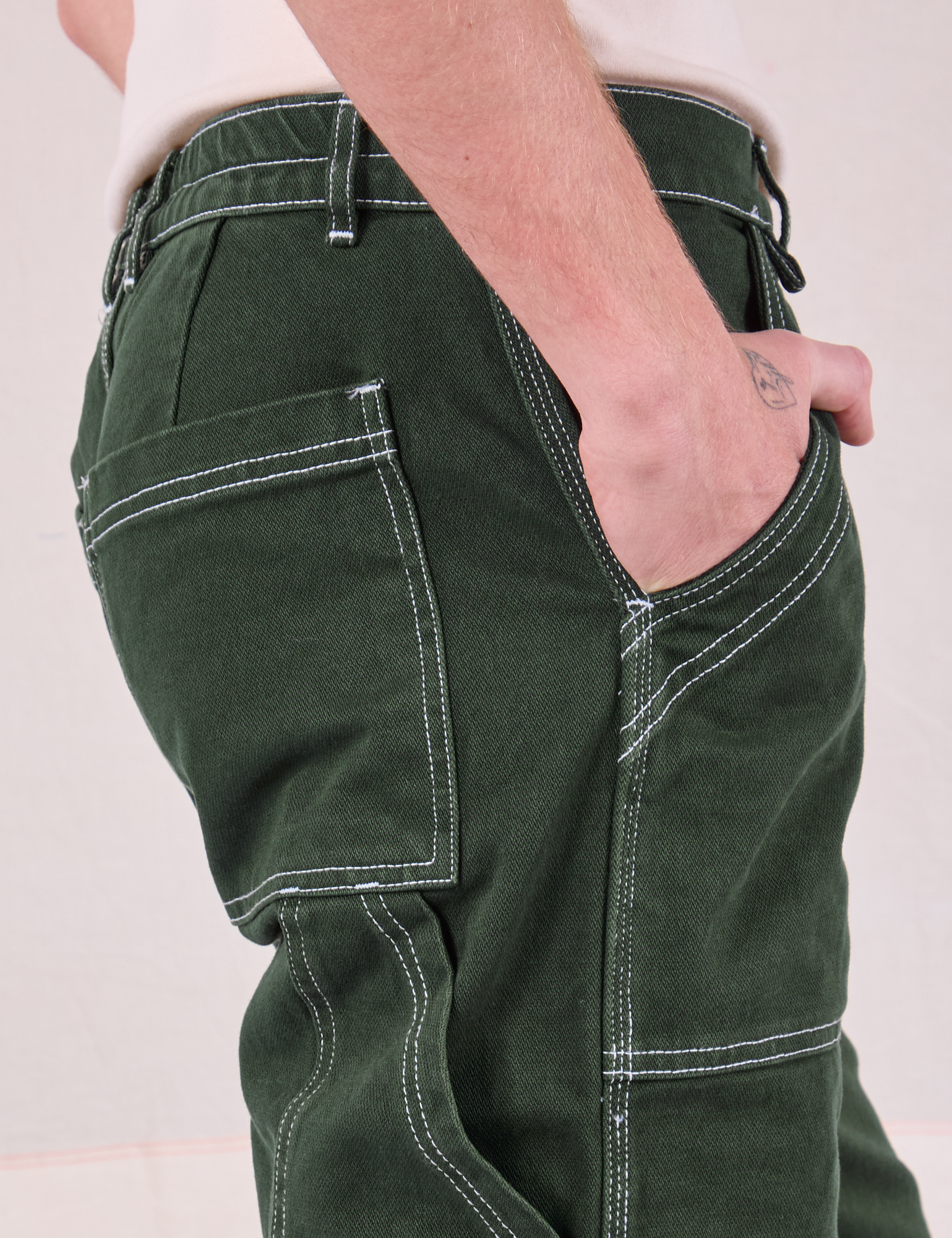 Carpenter Jeans in Swamp Green side close up on Quinn