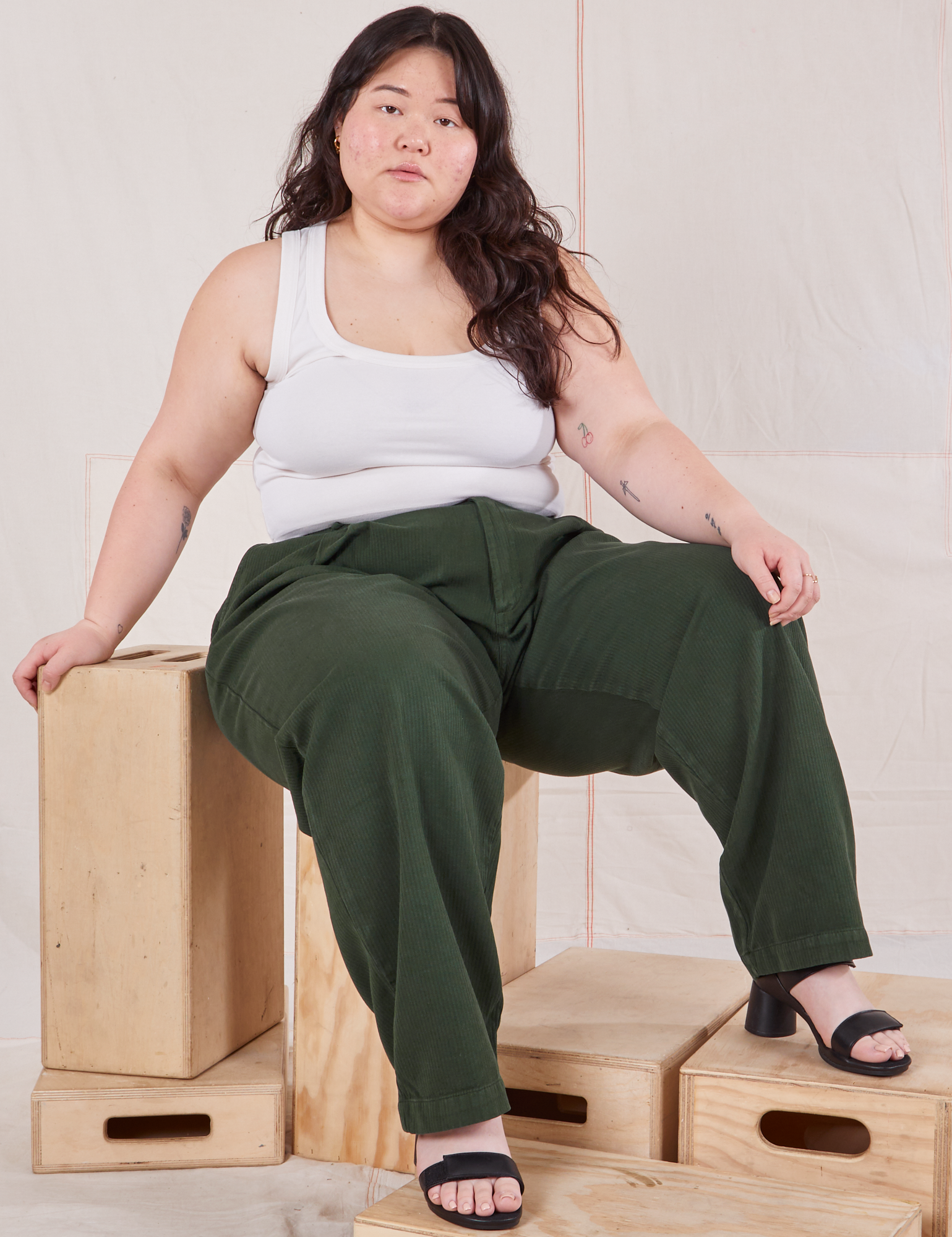 Ashley is wearing Heritage Trousers in Swamp Green and vintage off-white Cropped Tank Top