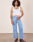 Jesse is wearing Cropped Tank Top in Vintage Off-White paired with light wash Sailor Jeans