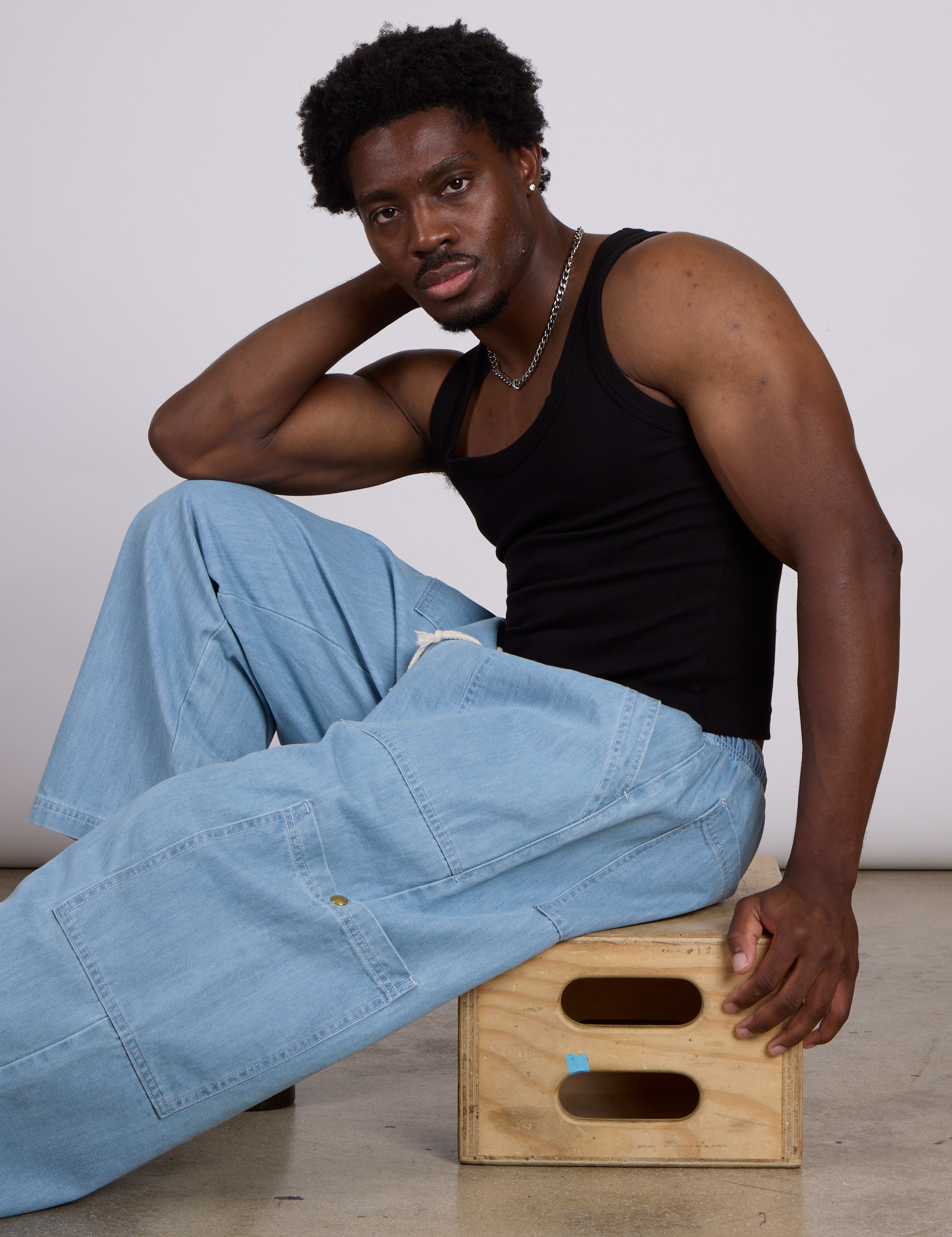 The Tank Top in Basic Black and light wash denim drop pocket pants on Isaac