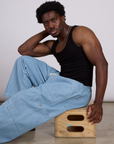 The Tank Top in Basic Black and light wash denim drop pocket pants on Isaac