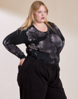 Angled front view of Long Sleeve Baby Tee in Ink Blot on Juliet