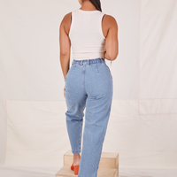 Back view of Denim Trouser Jeans in Light Wash and vintage off-white Tank Top worn by Gabi
