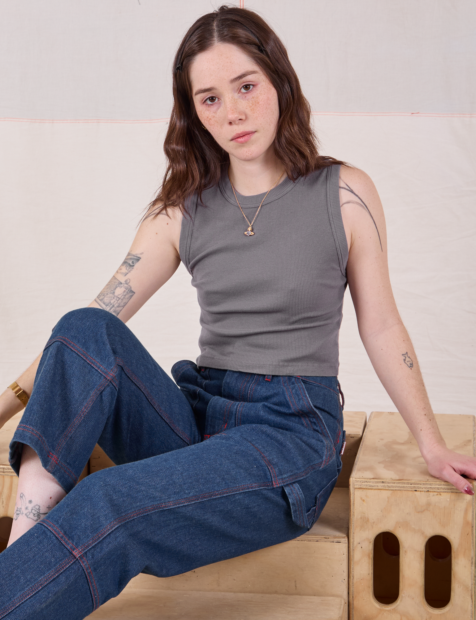 Hana is wearing Muscle Tee in Washed Grey and dark wash Carpenter Jeans