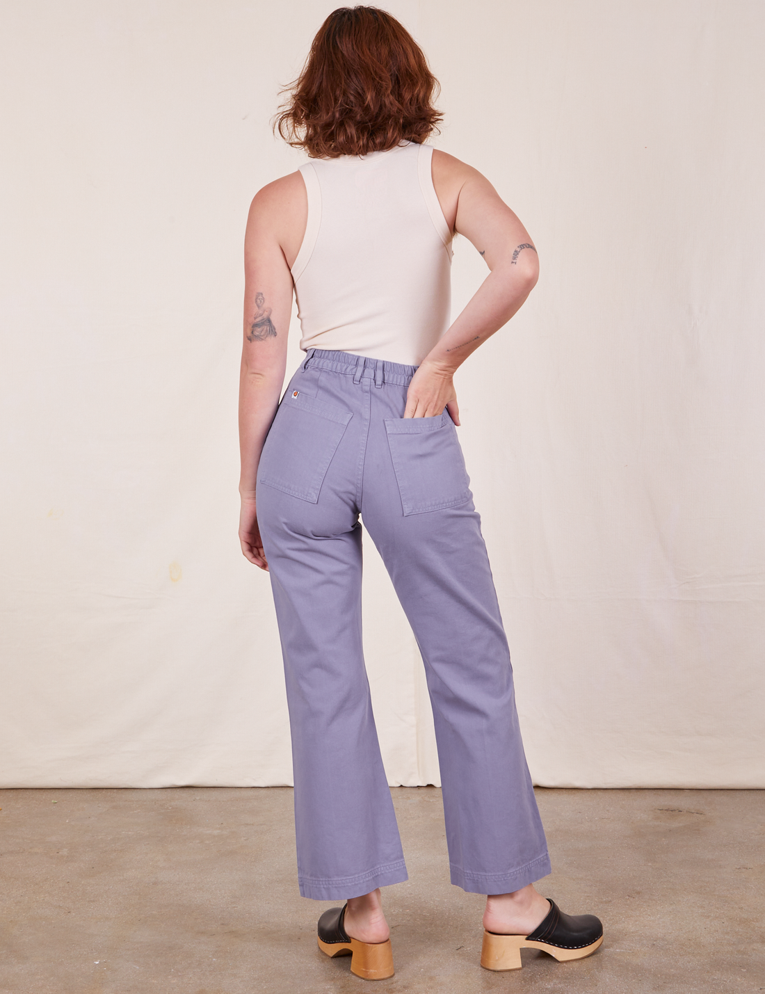 Back view of Western Pants in Faded Grape and vintage off-white Tank Top worn by Alex