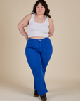 Ashley is 5’7” and wearing 1XL Work Pants in Royal Blue paired with a Cropped Tank in Vintage Tee White