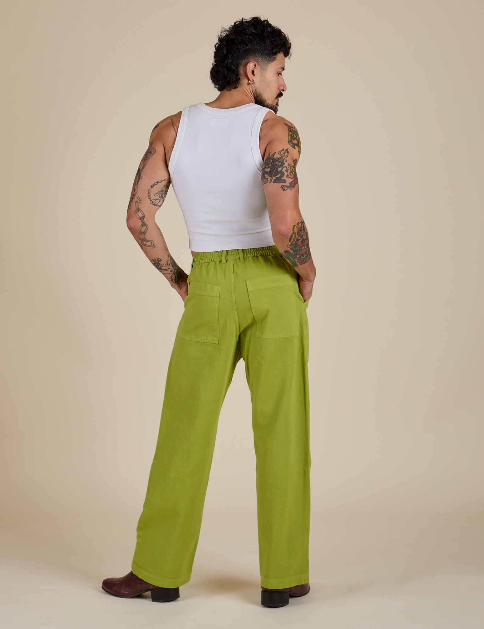 Back view of Work Pants in Gross Green and Cropped Tank in Vintage Tee White on Jesse