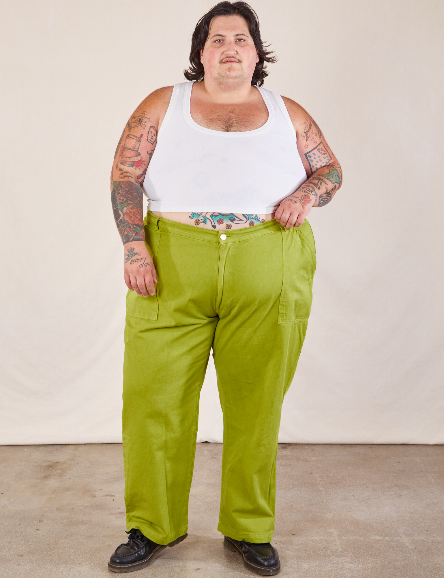 Sam is 5&#39;10 and wearing 4XL Work Pants in Gross Green paired with a Cropped Tank in vintage tee off-white