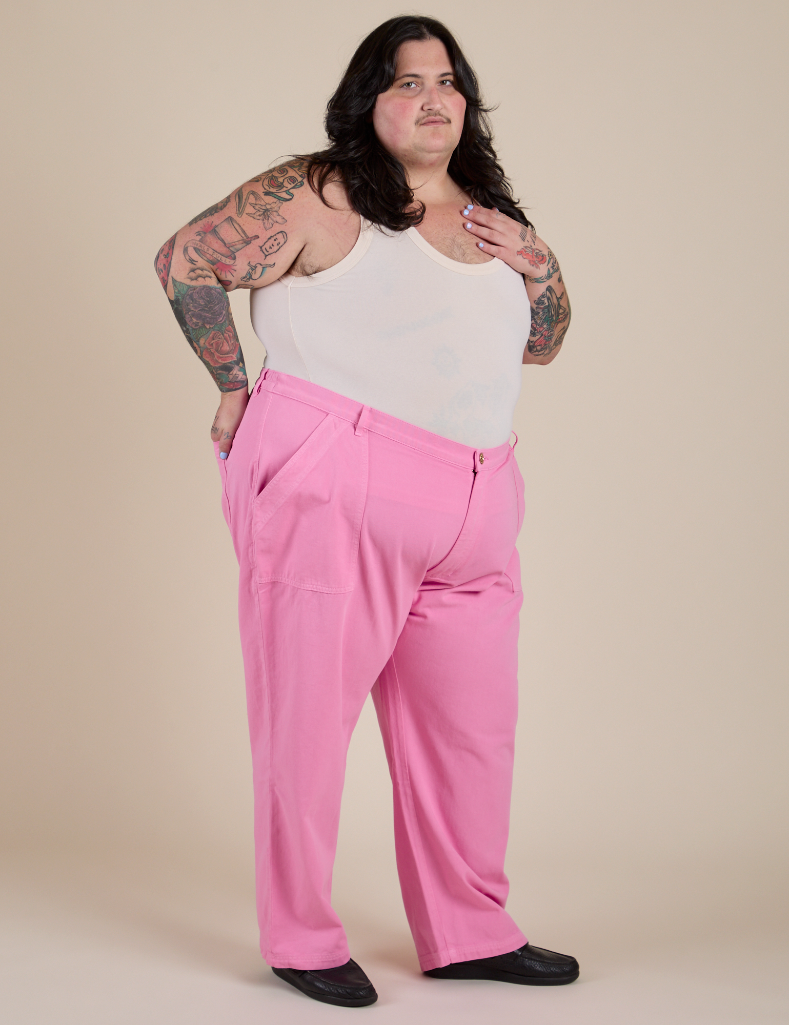 Angled front view of Work Pants in Bubblegum Pink paired with Cropped Tank in Vintage Tee White