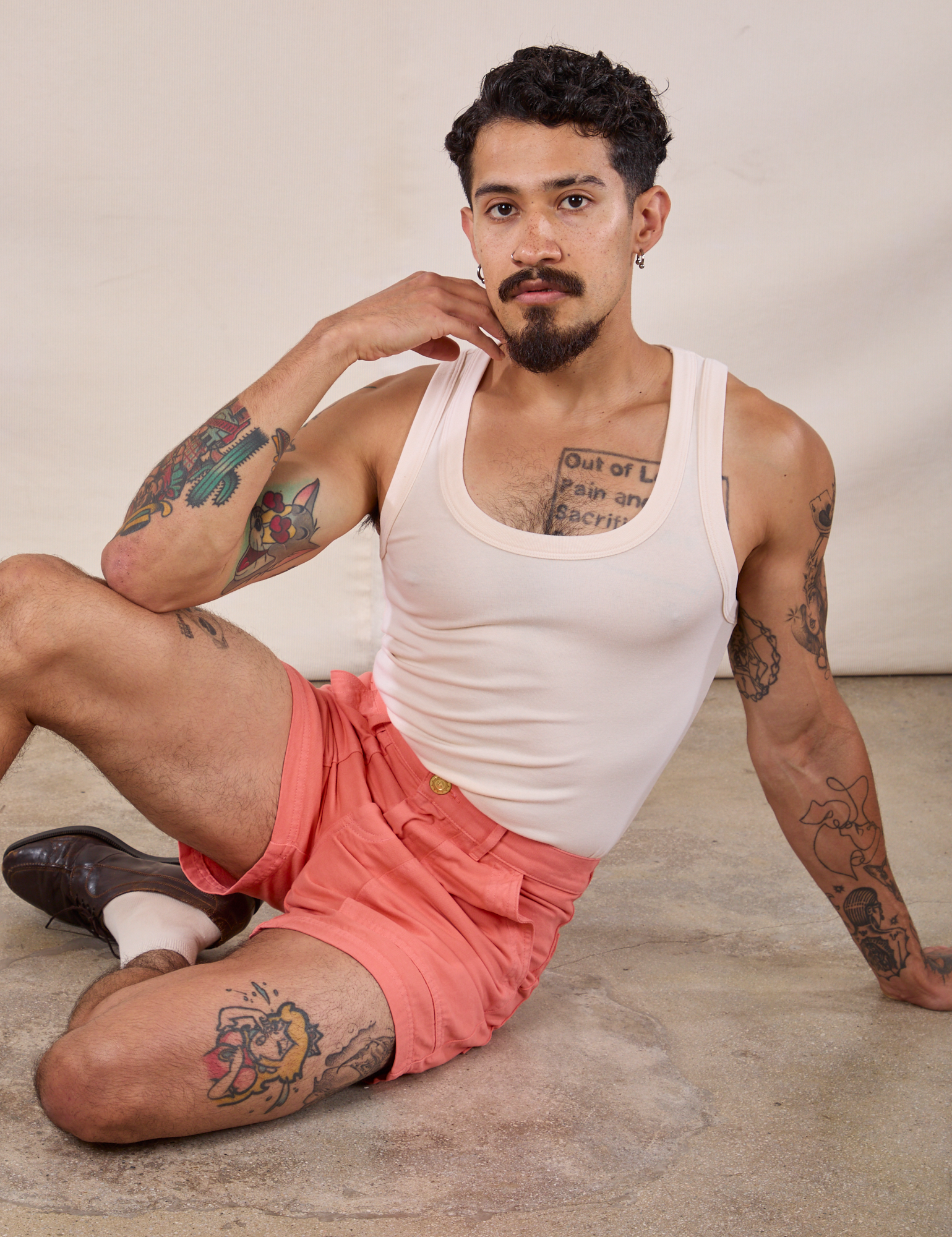 Jesse is wearing Classic Work Shorts in Flamingo Pink and Tank Top in Vintage Tee Off-White 