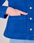 Close up of Alex's hand in the front pocket of Denim Work Jacket in Royal Blue