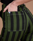 Close up of Alex's hand in the back pocket of Black Stripe Work Pants in Evergreen