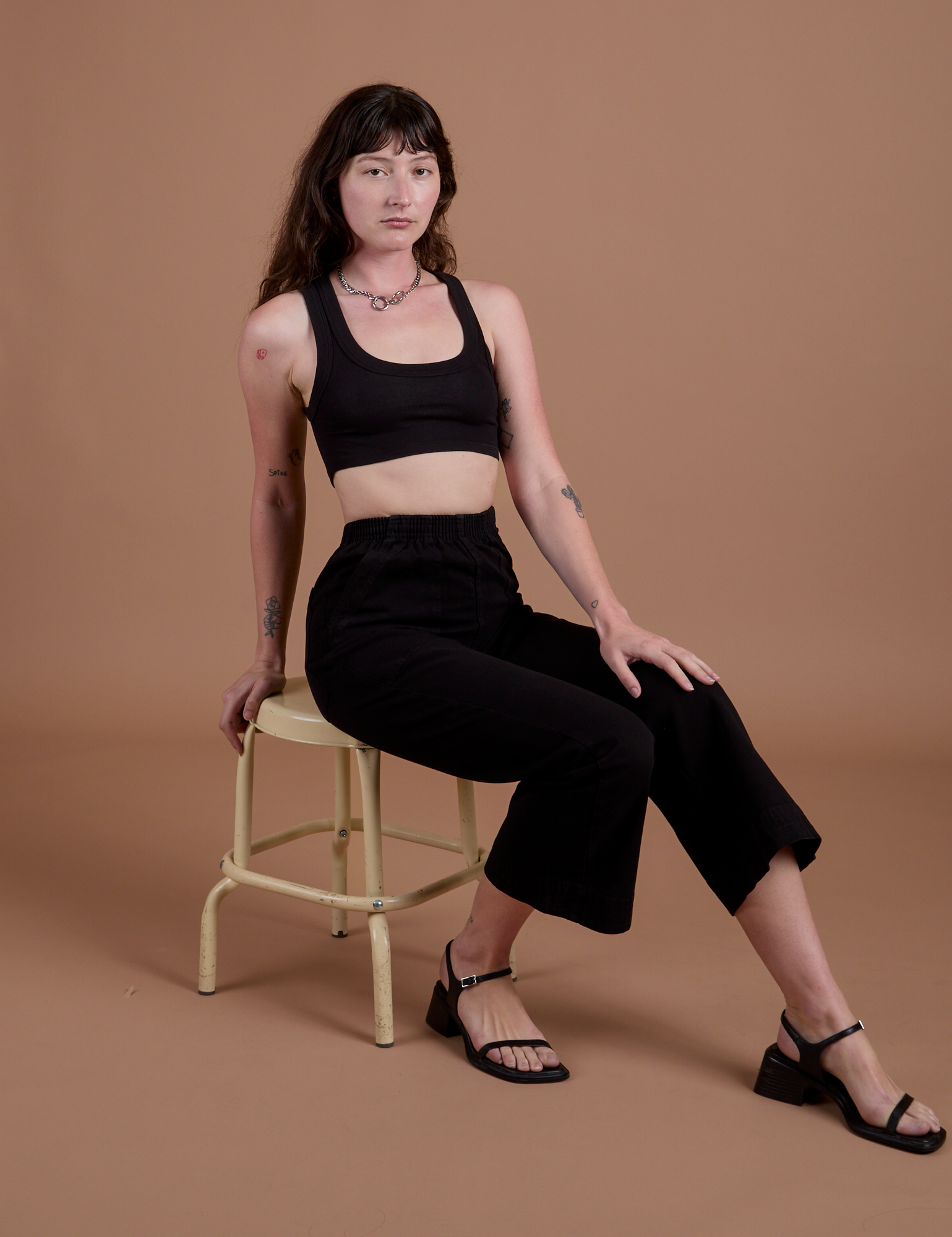 Alex is wearing Action Pants in Basic Black and Mini Tank in Black