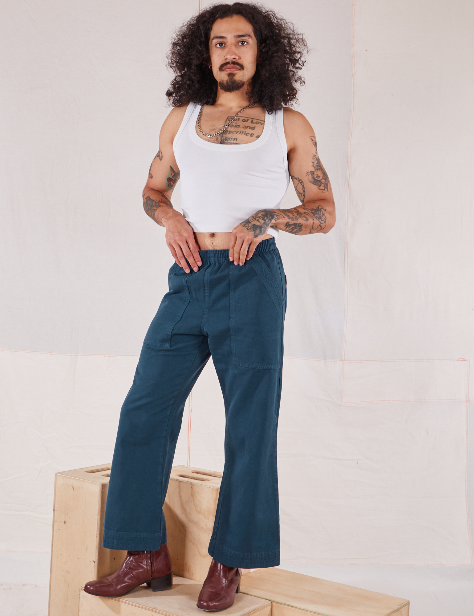 Jesse is 5&#39;8&quot; and wearing XXS Action Pants in Lagoon paired with a Cropped Tank in vintage tee off-white