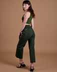 Angled back view of Action Pants in Swamp Green and evergreen Mini Tank on Alex