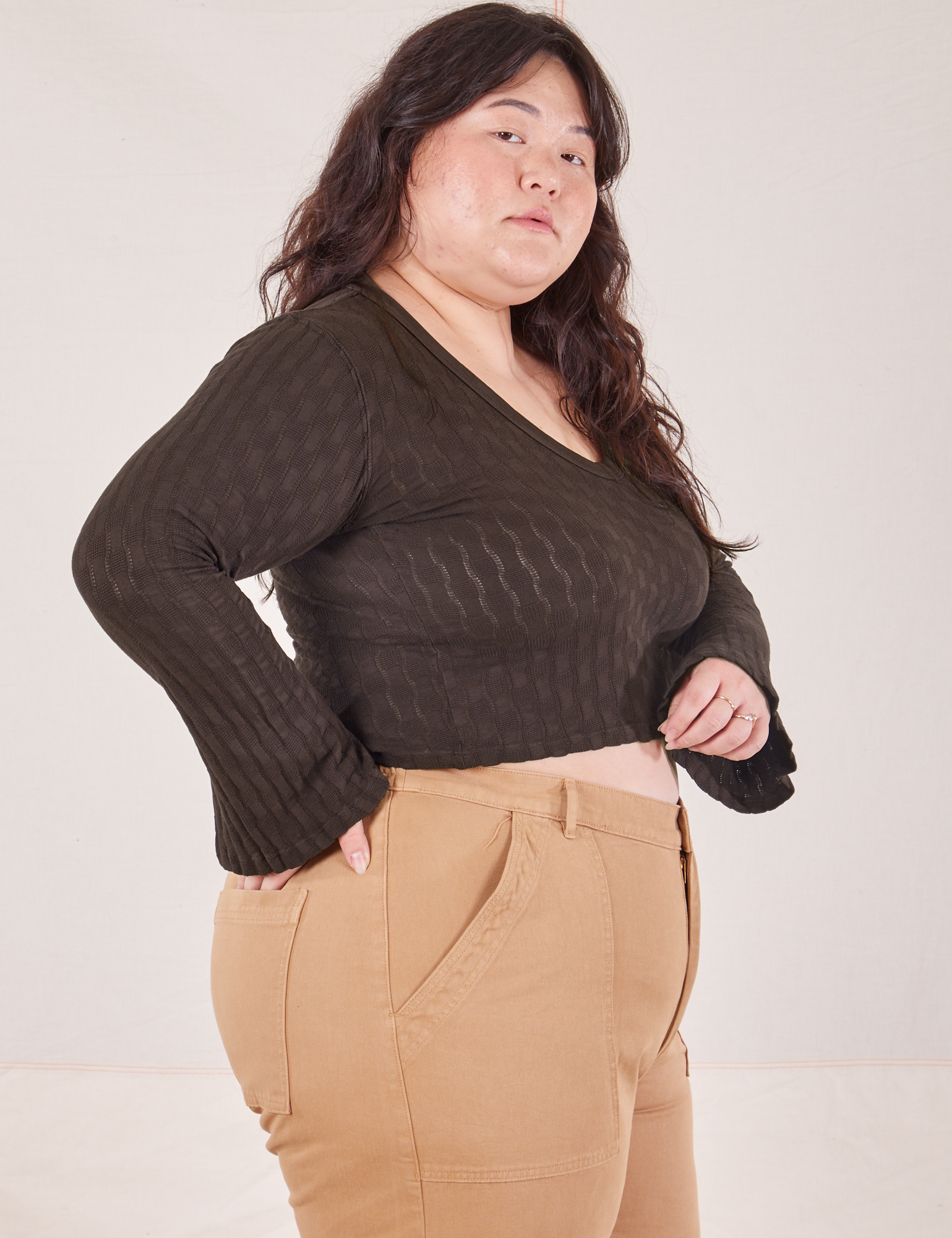 Side view of Bell Sleeve Top in Espresso Brown and tan Work Pants worn by Ashley