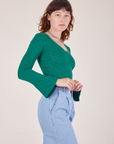 Side view of Bell Sleeve Top in Hunter Green worn by Alex