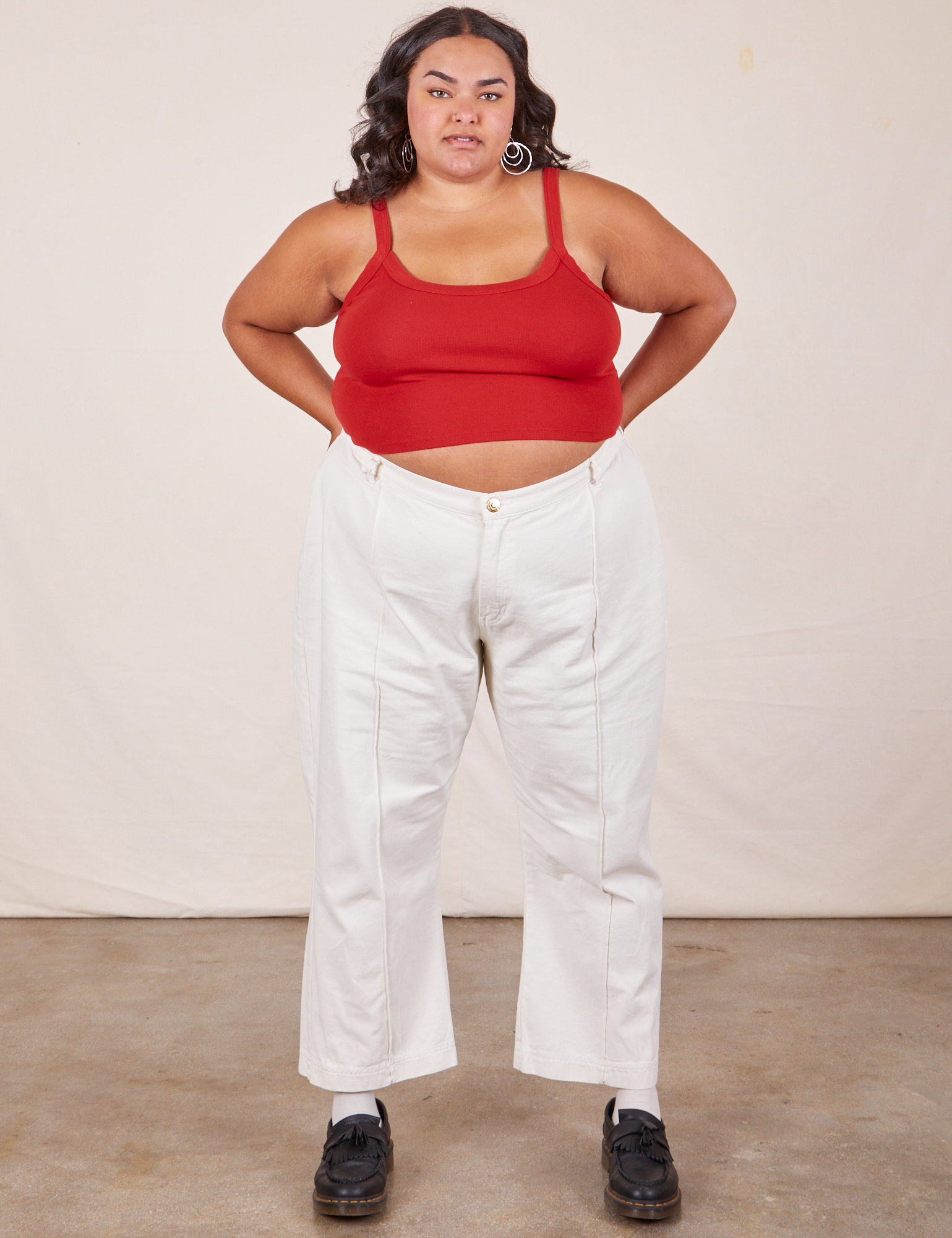 Alicia is wearing Cropped Cami in Mustang Red and vintage off-white Western Pants