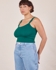 Angled view of Cropped Cami in Hunter Green and light wash Sailor Jeans worn by Tiara