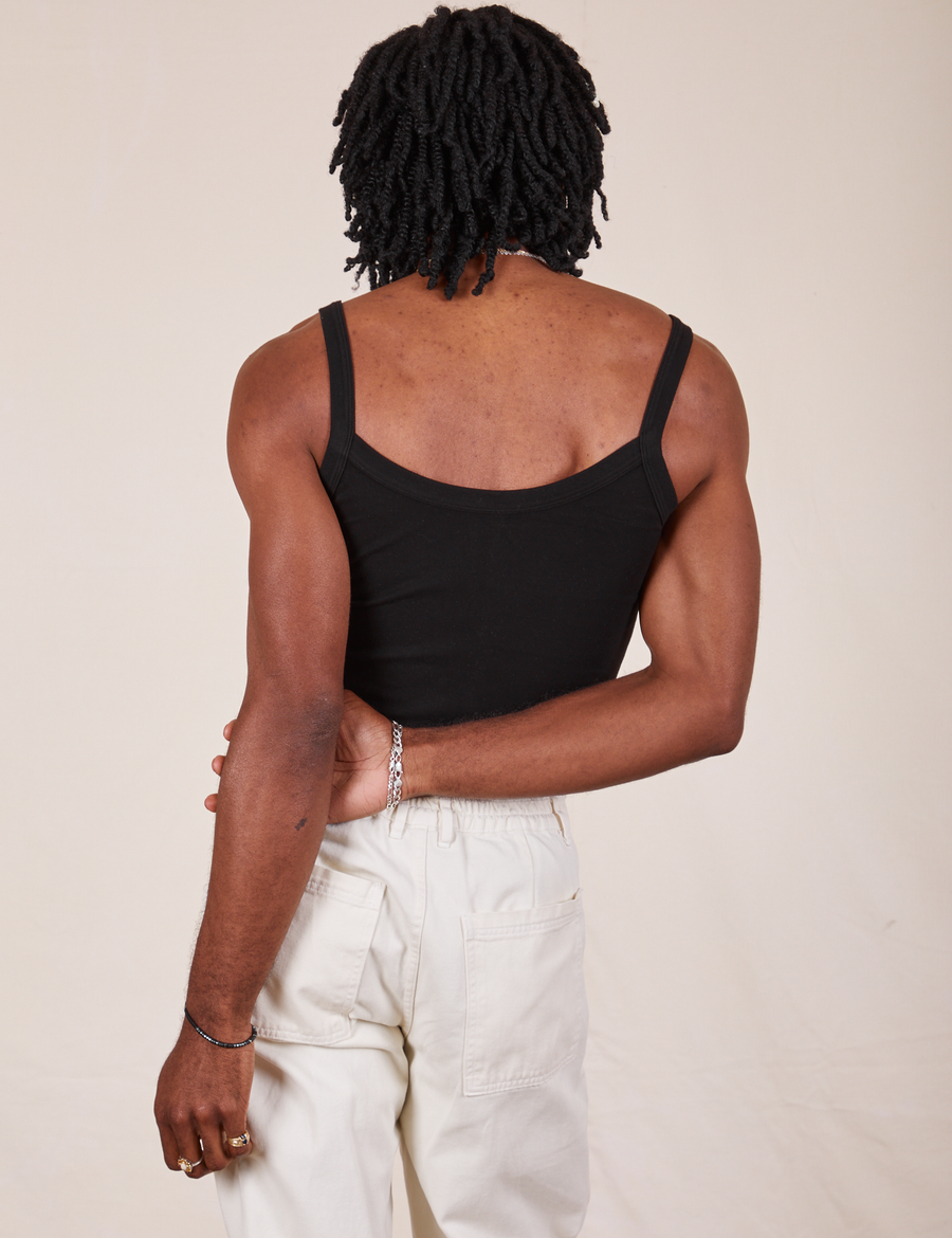 Back view of Cropped Cami in Basic Black and vintage off-white Western Pants worn by Jerrod