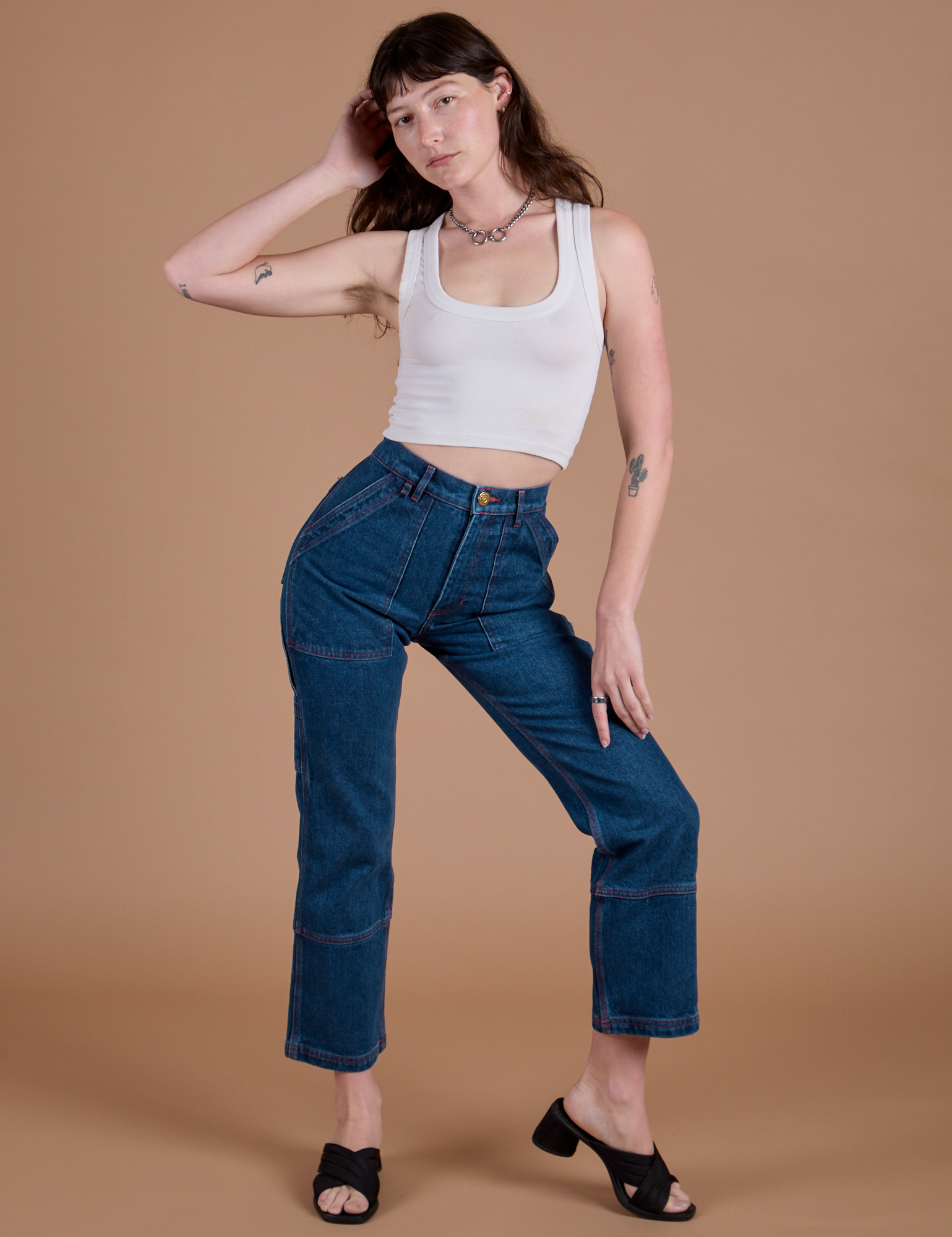 Alex is wearing Carpenter Jeans in Dark Wash and vintage tee white Cropped Tank