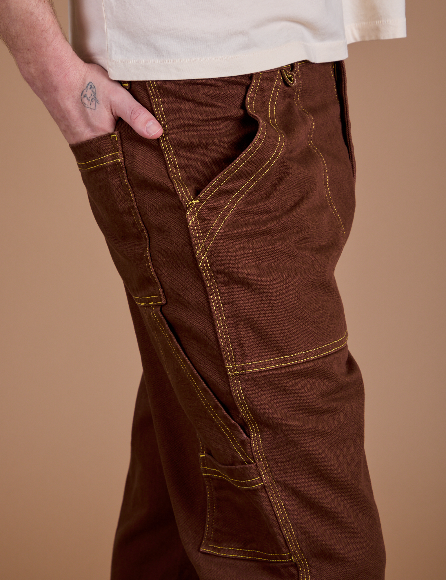 Carpenter Jeans in Fudgesicle Brown side close up on Quinn