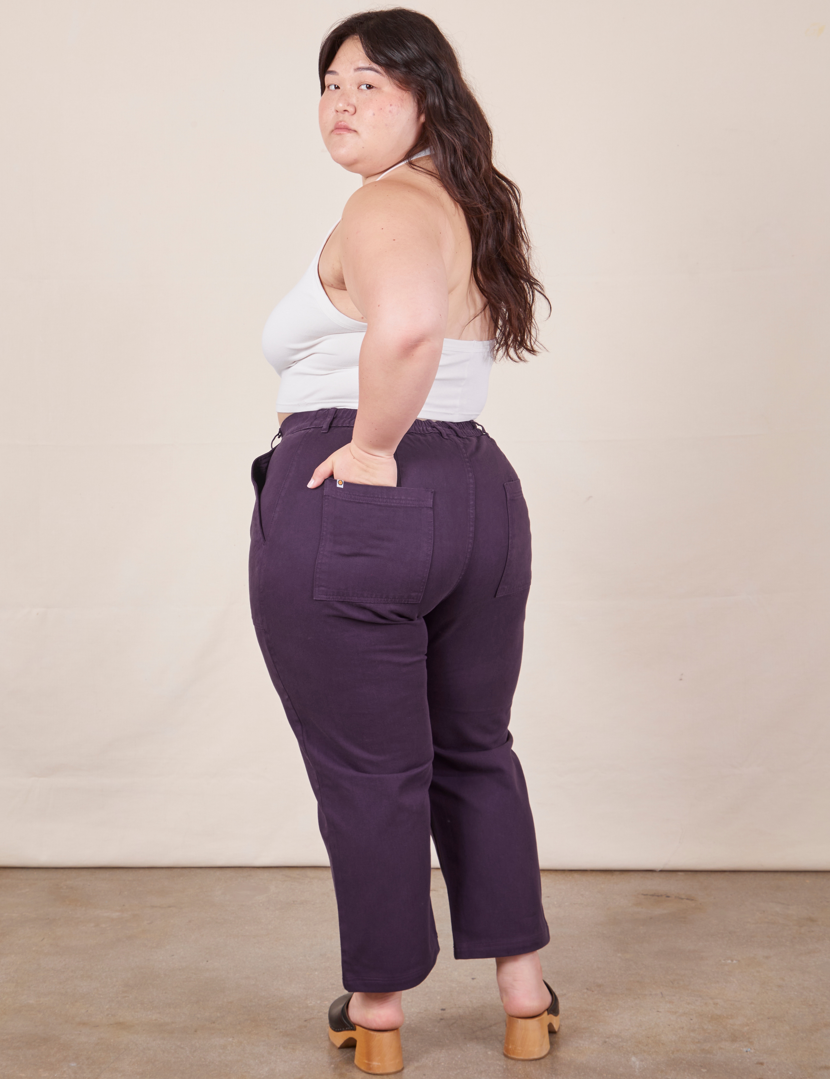 Angled back view of Petite Work Pants in Nebula Purple worn by Ashley