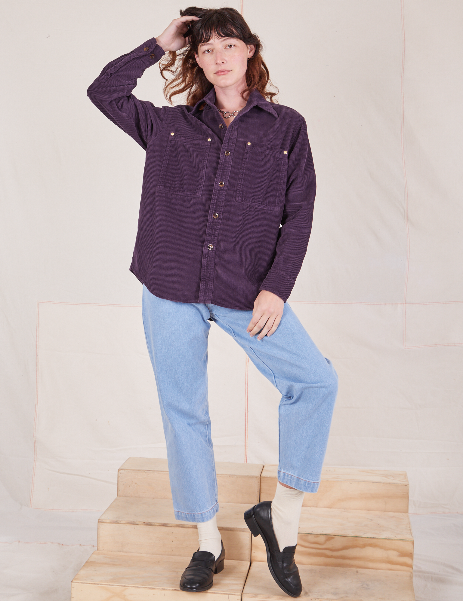 Alex is wearing a buttoned up Corduroy Overshirt in Nebula Purple and light wash Denim Trouser Jeans