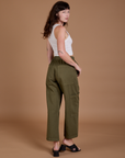 Angled back view of Drop Pocket Cargo Pants in Surplus Green on Alex