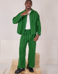 Isaac is wearing Summer Stripe Action Pants in Green On Green and matching Cropped Overshirt