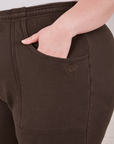 Rolled Cuff Sweat Pants in Espresso Brown front pocket close up. Ashley has her hand in the pocket.