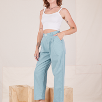 Angled view of Heavyweight Trousers in Baby Blue and vintage off-white Cropped Cami worn by Alex