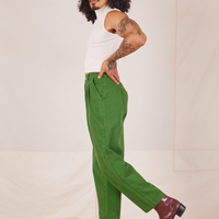 Side view of Heavyweight Trousers in Lawn Green and vintage off-white Sleeveless Turtleneck worn by Jesse