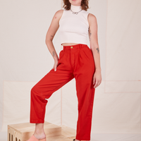 Alex is wearing Heavyweight Trousers in Mustang Red and vintage off-white Sleeveless Turtleneck