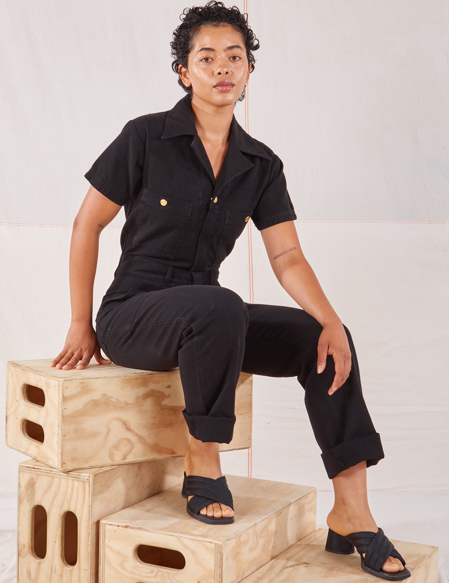 Mika is wearing Heritage Short Sleeve Jumpsuit in Basic Black