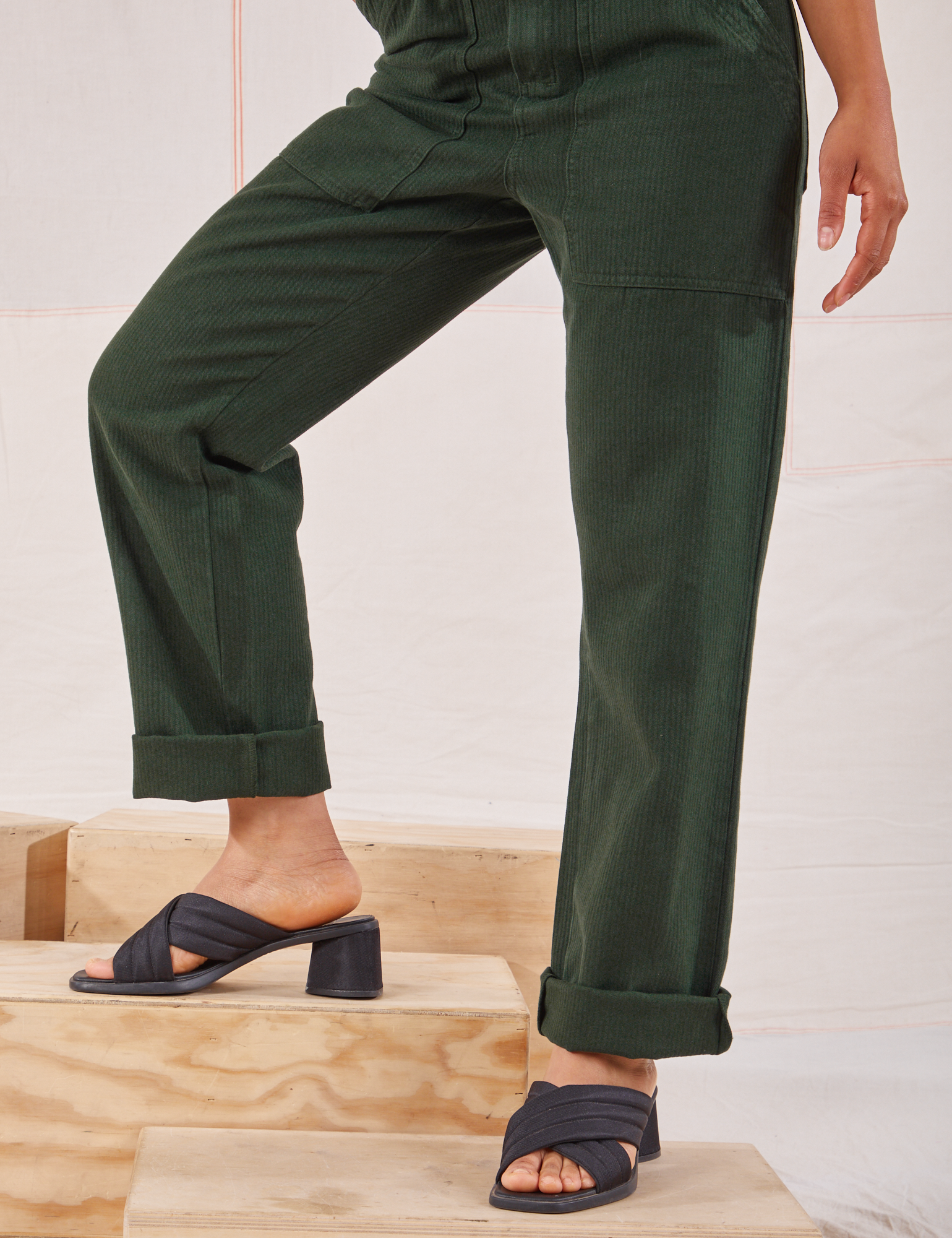 Heritage Short Sleeve Jumpsuit in Swamp Green pant leg close up on Mika