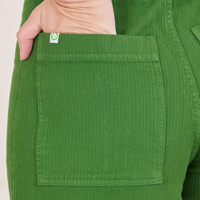 Heritage Westerns in Lawn Green back pocket close up. Alex has her hand in the pocket.