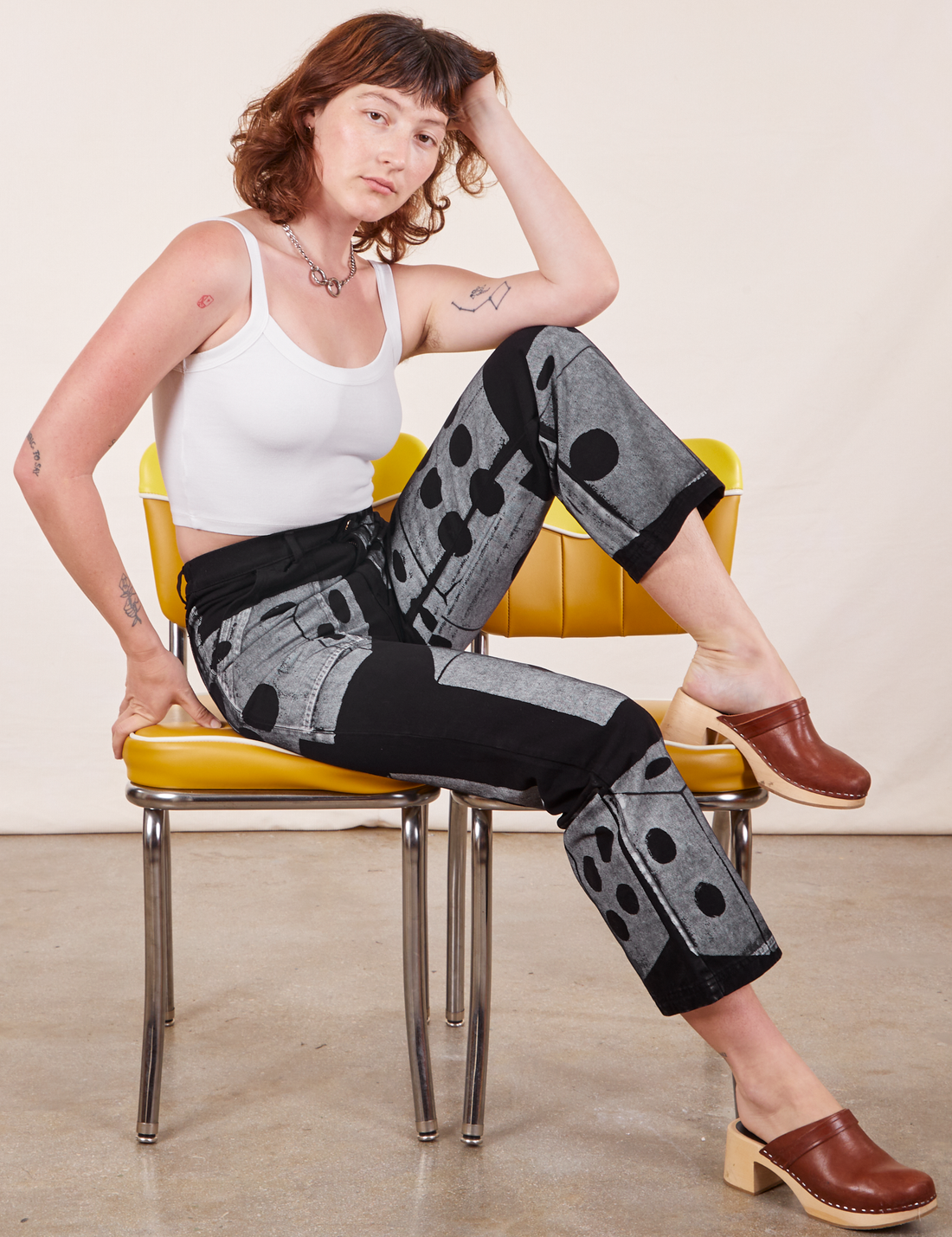 Alex is wearing Icon Work Pants in Dice and vintage off-white Cropped Cami