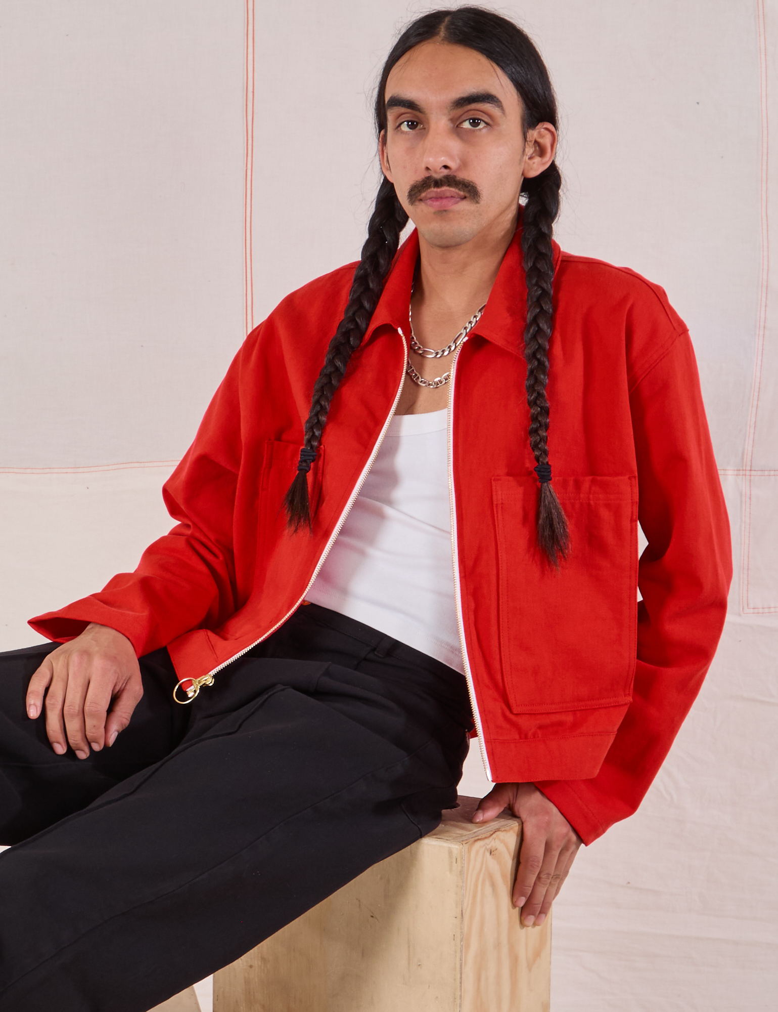 Anthony is wearing Mechanic Jacket in Mustang Red and black Western Pants
