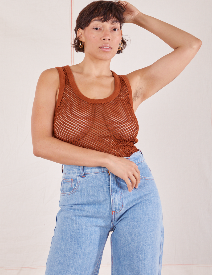 Tiara is 5'4" and wearing XS Mesh Tank Top in Burnt Terracotta paired with light wash Sailor Jeans