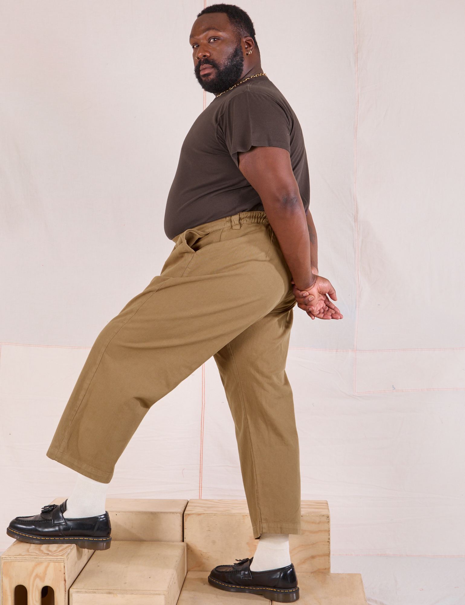 Side view of Mid-Rise Pleated Trousers in Desert Brown and espresso brown Organic Vintage Tee