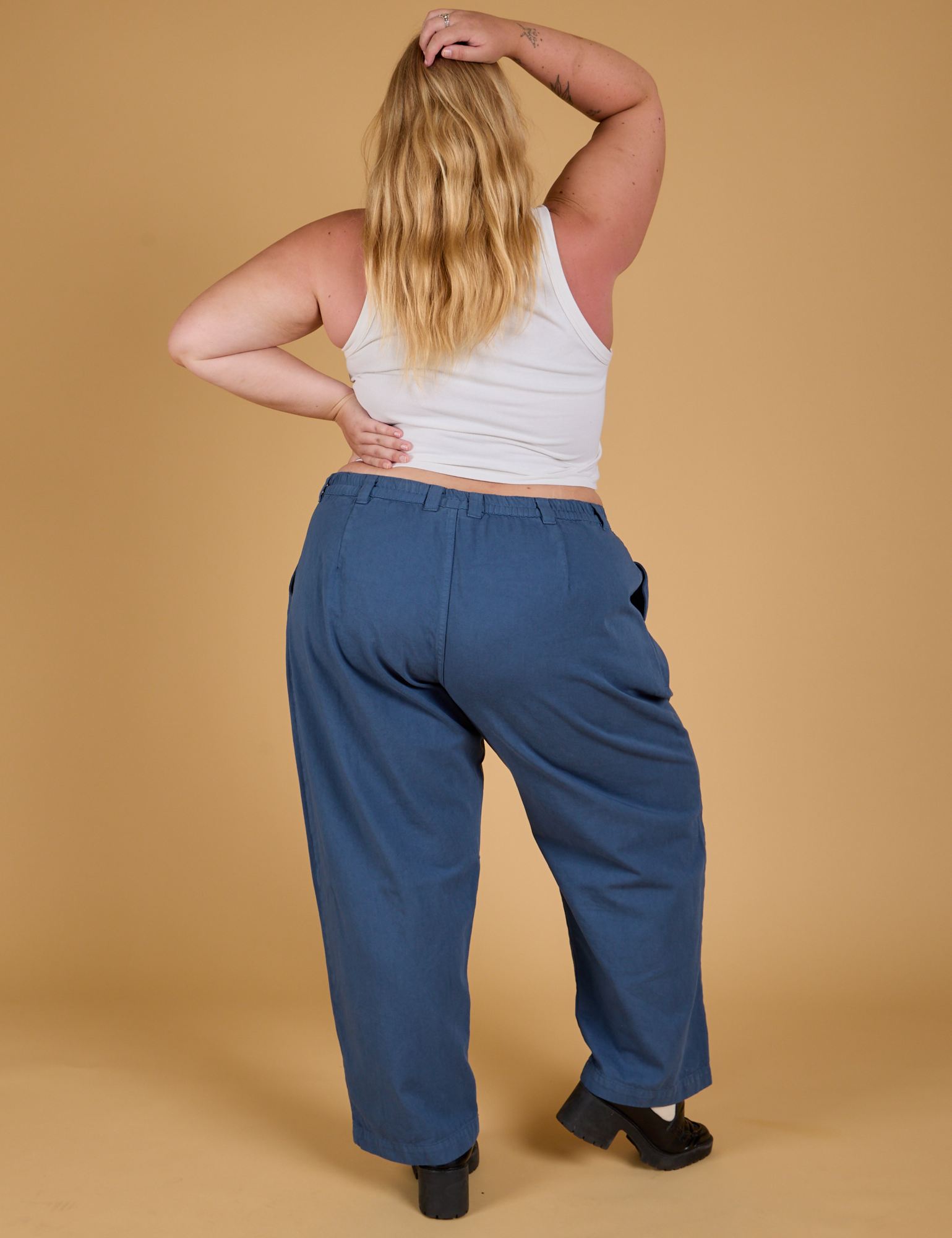 Back view of Baggy Mid-Rise Trousers in French Blue and vintage tee white Cropped Tank on Juliet