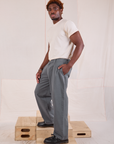 Side view of Mid-Rise Pleated Trousers in Slate Grey and Organic Vintage Tee in vintage tee off-white on Issac