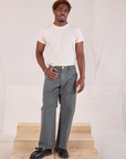 Issac is 5'10" and wearing M Mid-Rise Work Pants in Slate Grey paired with an Organic Vintage Tee in vintage tee off-white