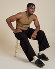 Isaac is wearing Muscle Tee in Desert Brown and black Drop Pocket Cargo Pants